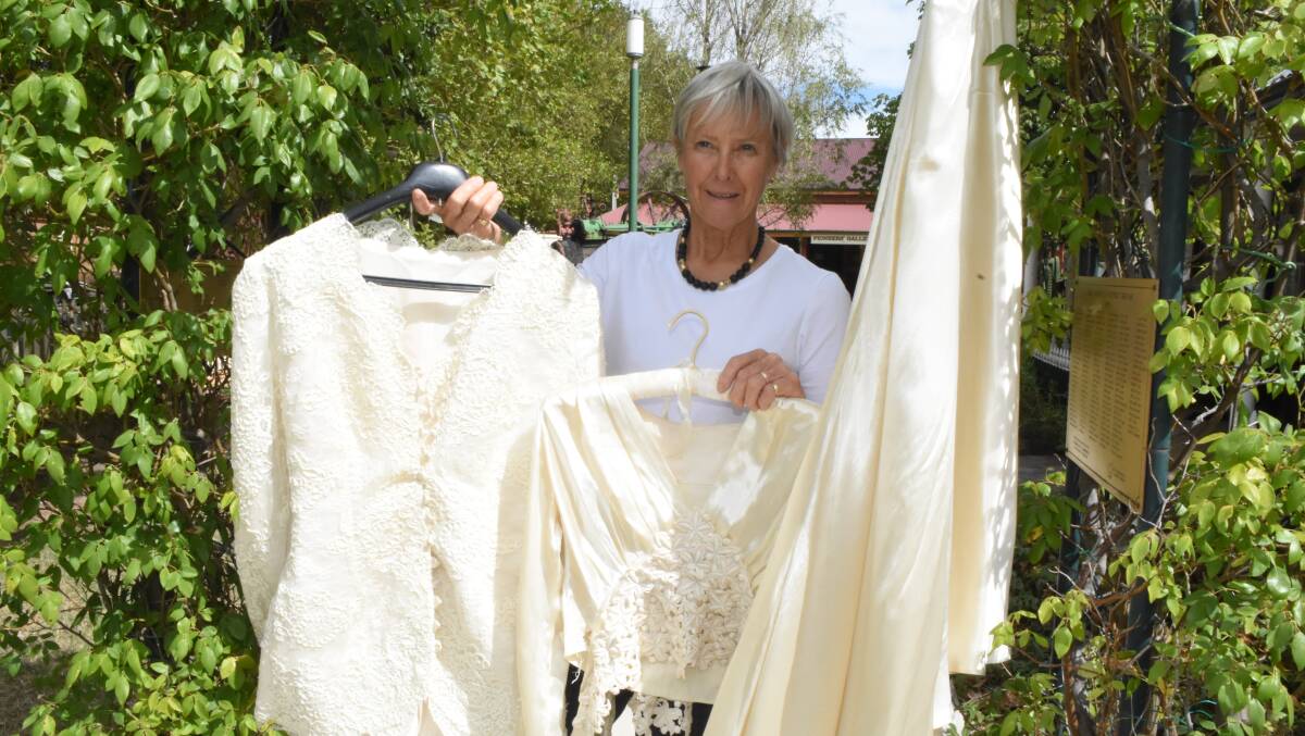 Women in white: Di Shepherd with her mother's wedding dress which will be just one of dozens on display this Saturday.