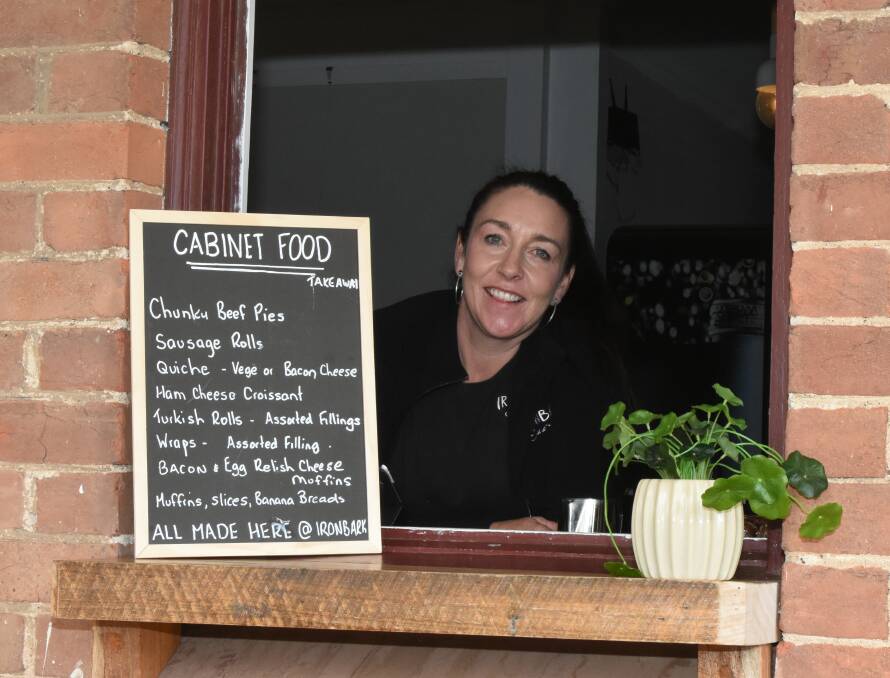 Katrina Toshack in her coffee window and her cabinet offerings.