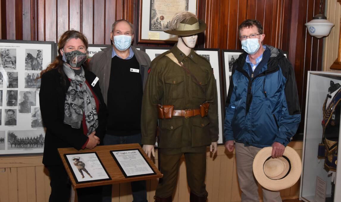 New display: Hayley Lavers, Bruce Chapman and Andrew Gee with the new mannequin inside the museum. Photos: Mark Logan.