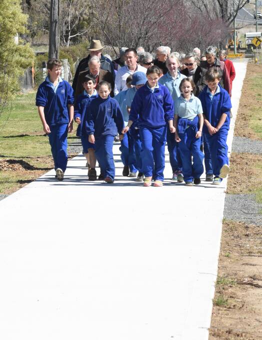 Marching on: Students and residents from Lyndhurst joined Paul Toole for a walk along a recently finished section of footpath.