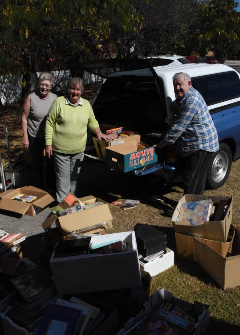 Packing them in: Janet Power, Elizabeth Russ and Don Bell taking another delivery of books for the Blayney Anglican Book Fair. Photo: Mark Logan.