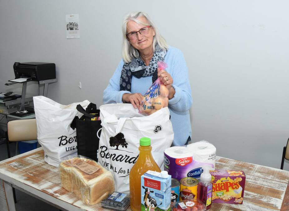 HELPING HAND: Jenny Summerson packing up a larger than usual hamper for a family with four children in Blayney.