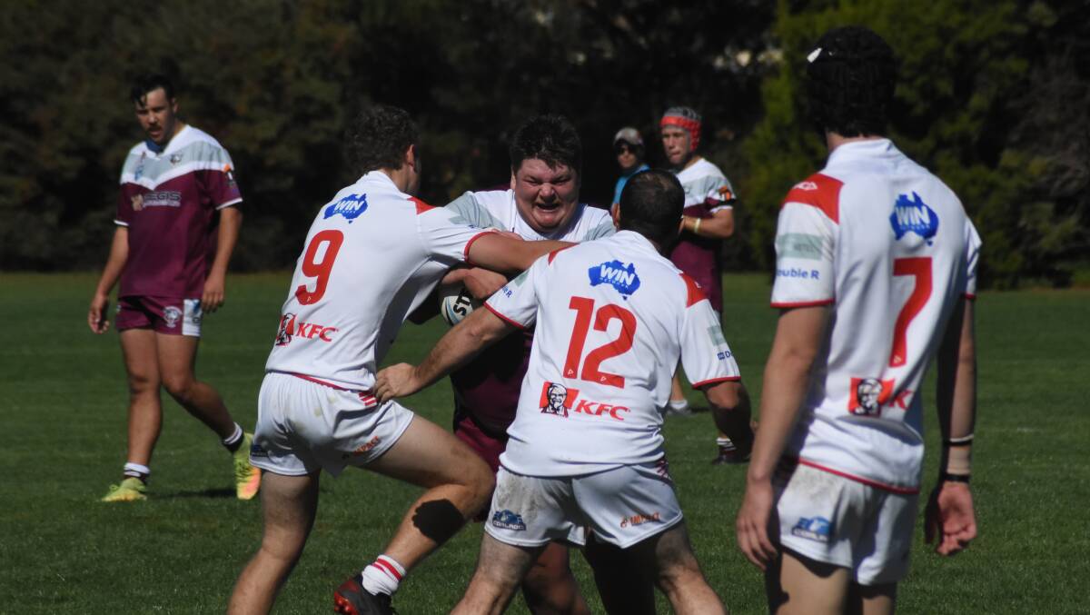 Zack Farr gets smothered by Mudgee Dragons players during the Bears first round match in May. Photo: Mark Logan