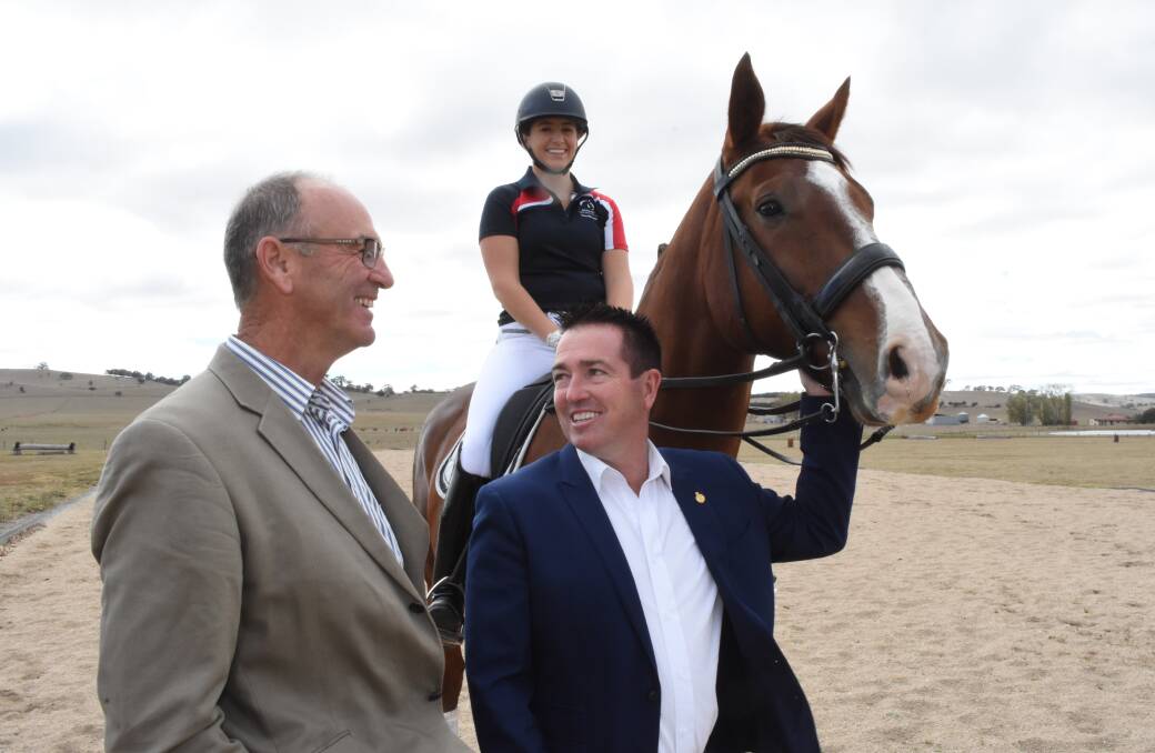 All smiles: Scott Ferguson and Paul Toole, along with Bathurst rider Sarah Farraway, at the site of the new Equestrian centre. Photo: Mark Logan.