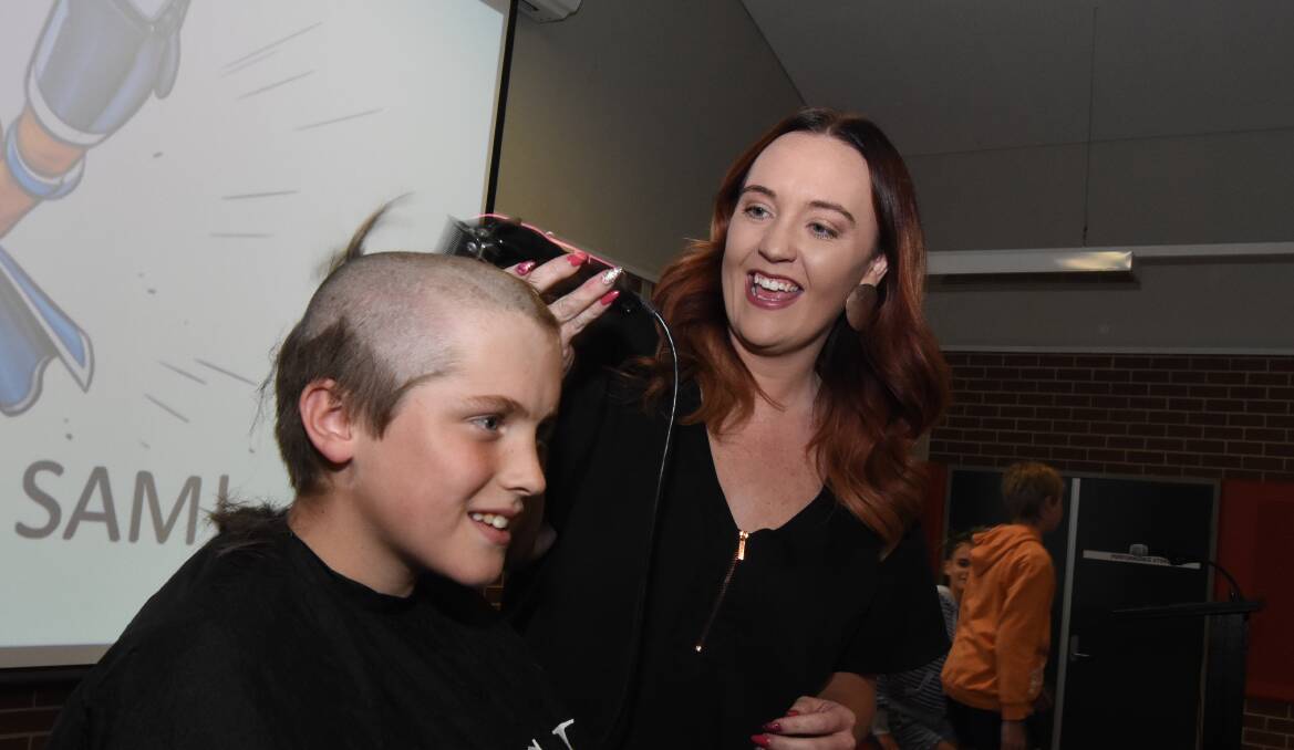Greatest cut of all: Lucy Thompson cleanly removes Sam Taylor's hair after he raised over $800 for Shave for a Cure. Photo: Mark Logan.