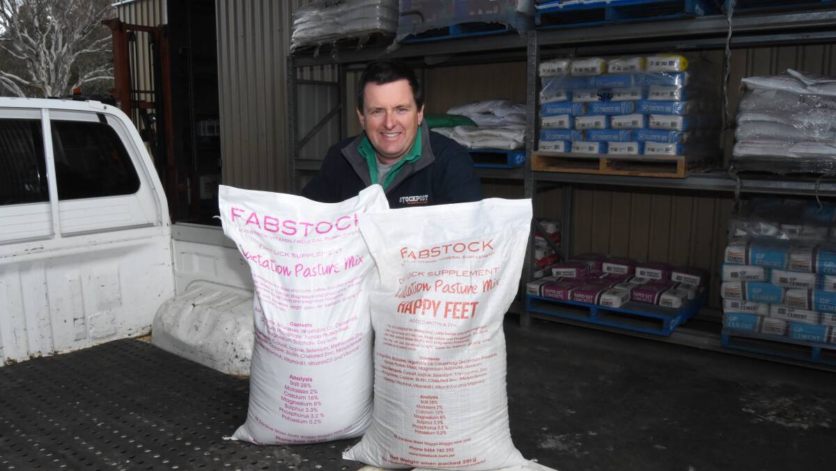 RELIEF: Mark Richardson with one of the mineral supplements available to help stop cows from developing Grass Tetany. Photo: Mark Logan.