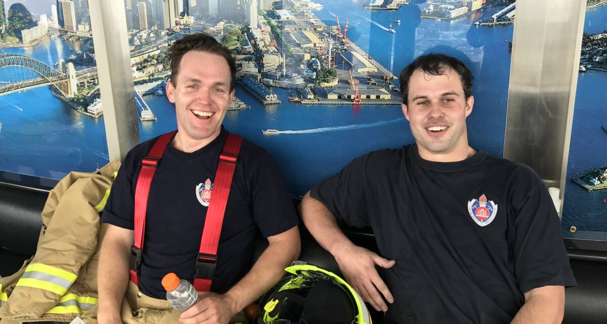 Exhausted: James Collins and Adam hamilton after they arrived at the top of Sydney Tower. Photo: Contributed.