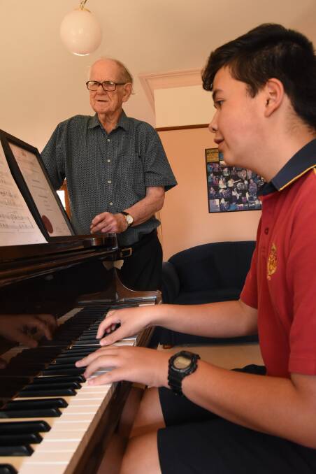 On key: James Sheahan student Bprem Zakaria practising his next piece of music for his exams under the watchful eye of music teacher Ray James. Photo: Mark Logan.
