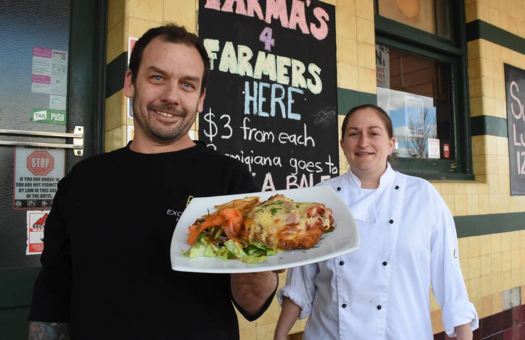 Goodness: Marty Russell and Kathryn Cumberland with 
one of their chicken parmas. Photo: Mark Logan.