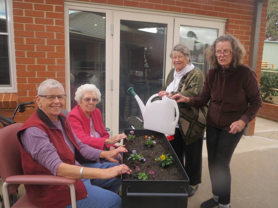 Green thumbs: Robyn Cheney, Shirley Hooke, Joan Parkes and Marg Sharwood with one of the raised garden beds. Photo: Contributed.