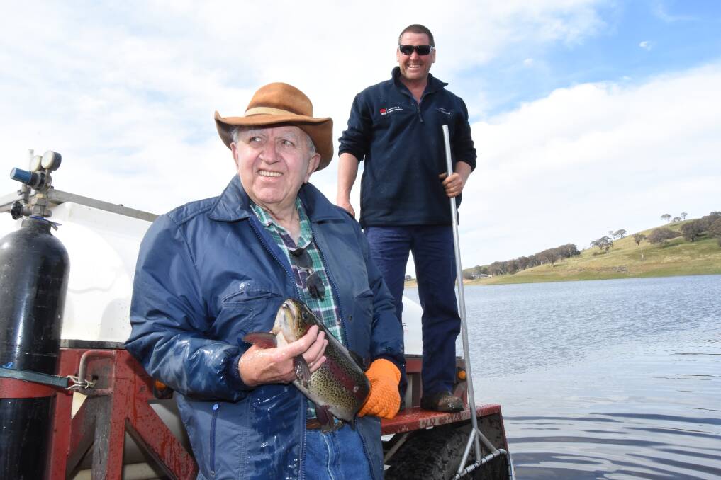 Hooked on fishing: Tom Williams with Fisheries NSW Peter Selby during the release of 100 mature Rainbow trout at Carcoar Dam. Photo: Mark Logan.
