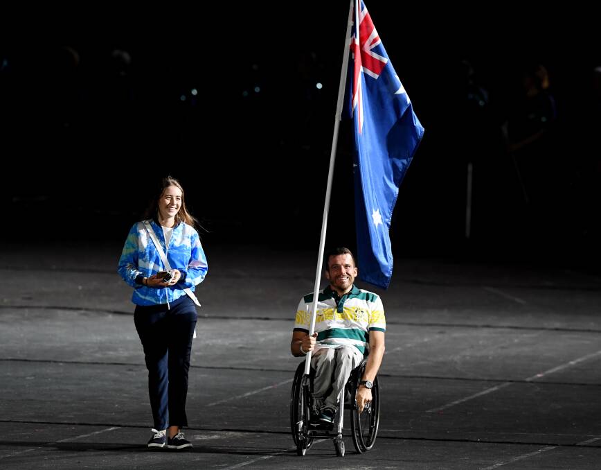 PROUD MOMENT: Kurt Fearnely became the first Para athlete to carry the national flag at a Commonwealth Games closing ceremony on Sunday night. Photo: AAP
