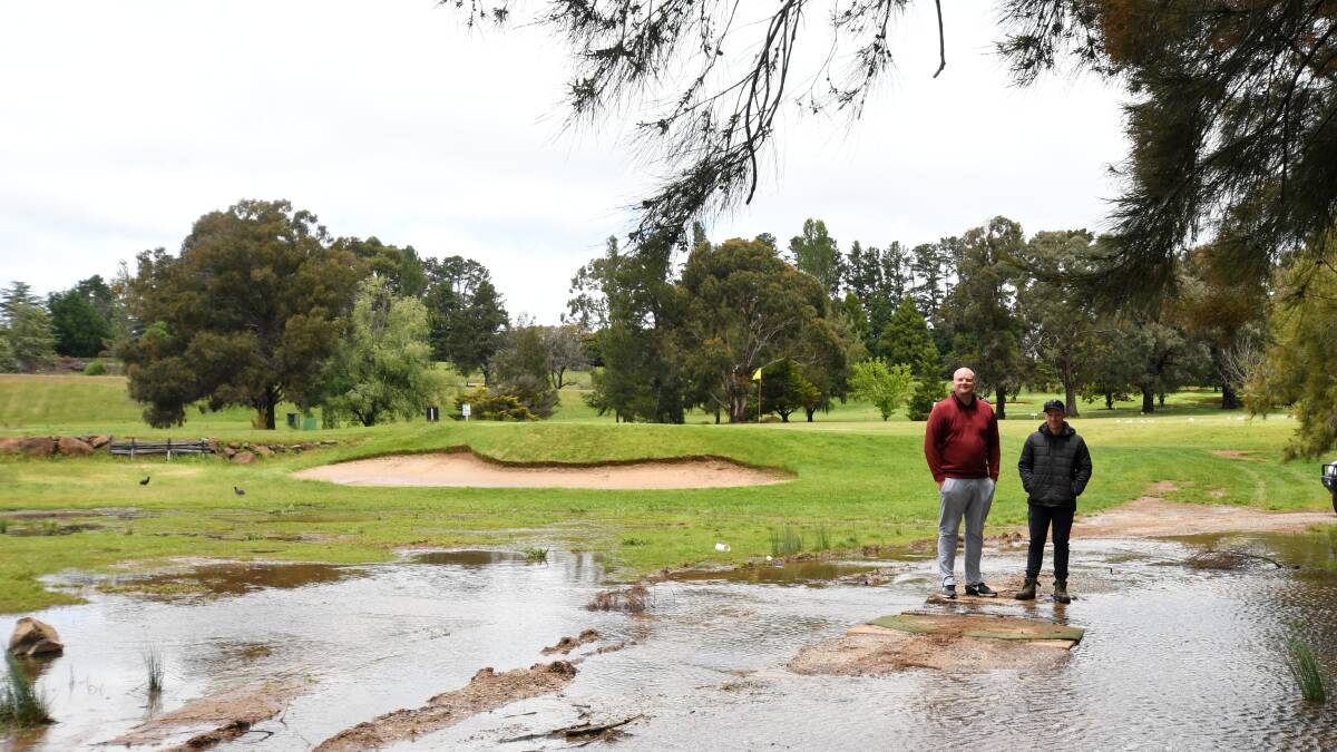 DELAY: Todd Brakenridge and Josh Sims (groundskeeper) at Wentworth on Monday following a weekend of rain. Photo: CARLA FREEDMAN