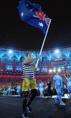 Gold medalist Curtis McGrath carries the flag for Australia during the closing ceremony of the 2016 Paralympic games in Rio. Photo: Atsushi Tomura
