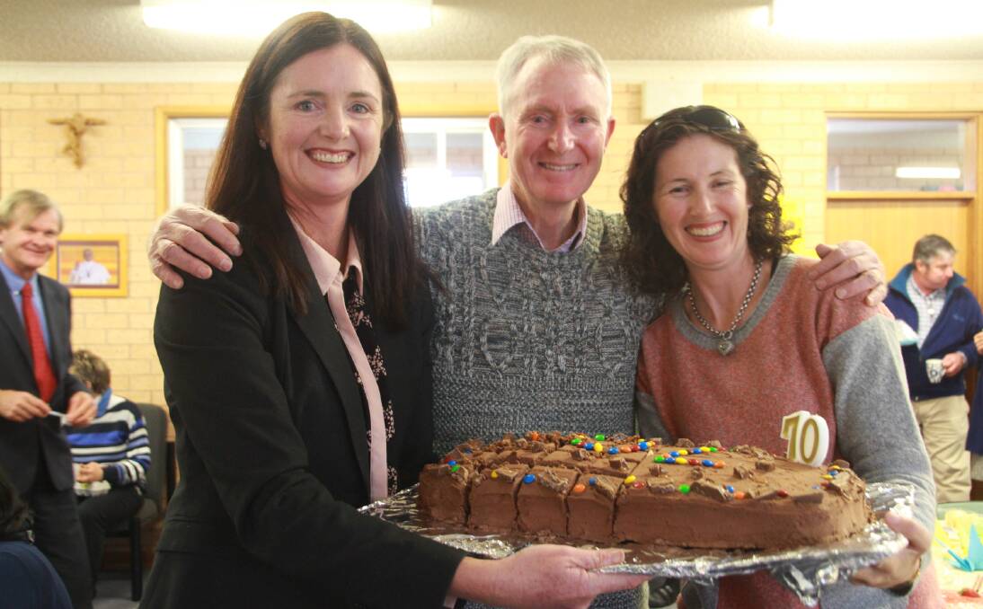BIRTHDAY BOY: James Sheahan Catholic High School Japanese teacher John Clarke celebrates turning 70 with his daughters Michelle Whiteley and Helen Clarke. Photo: CONTRIBUTED