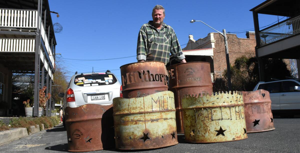 CREATIVE TOUCH: Rod de Vries made customised fire drums to light up Millthorpe's main street for Friday night's market. Photo: MARK LOGAN