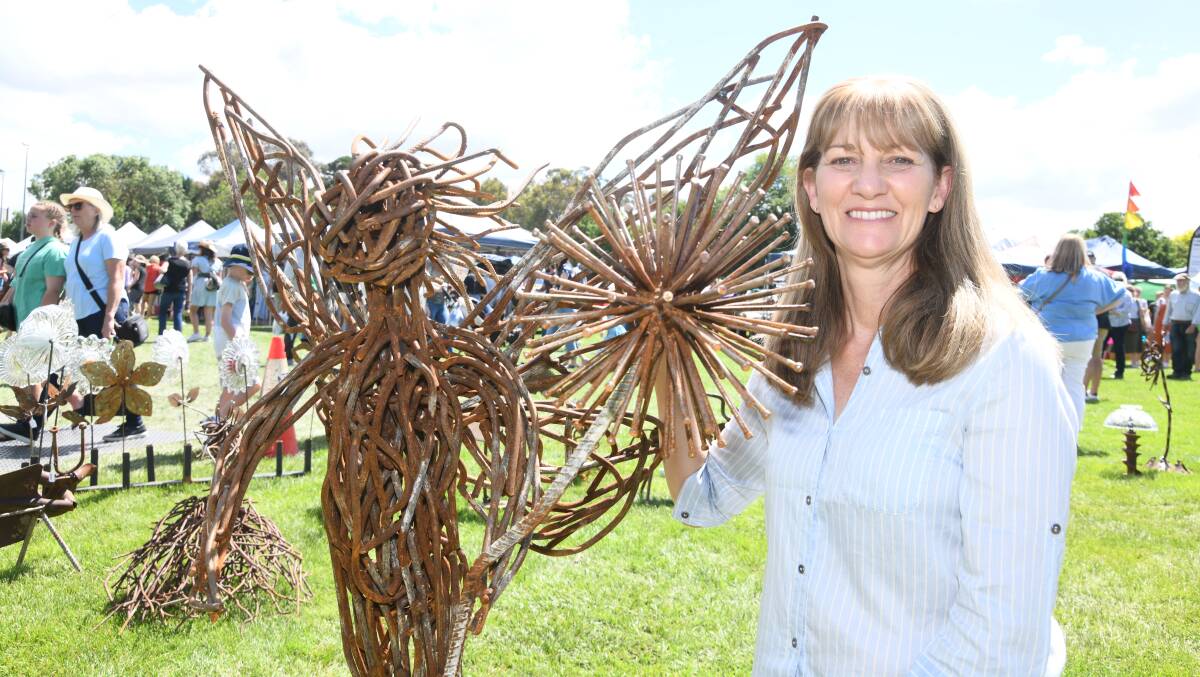 Jenny Shea with medal sculptures she made at the Millthorpe Markets on Sunday. Picture by Jude Keogh