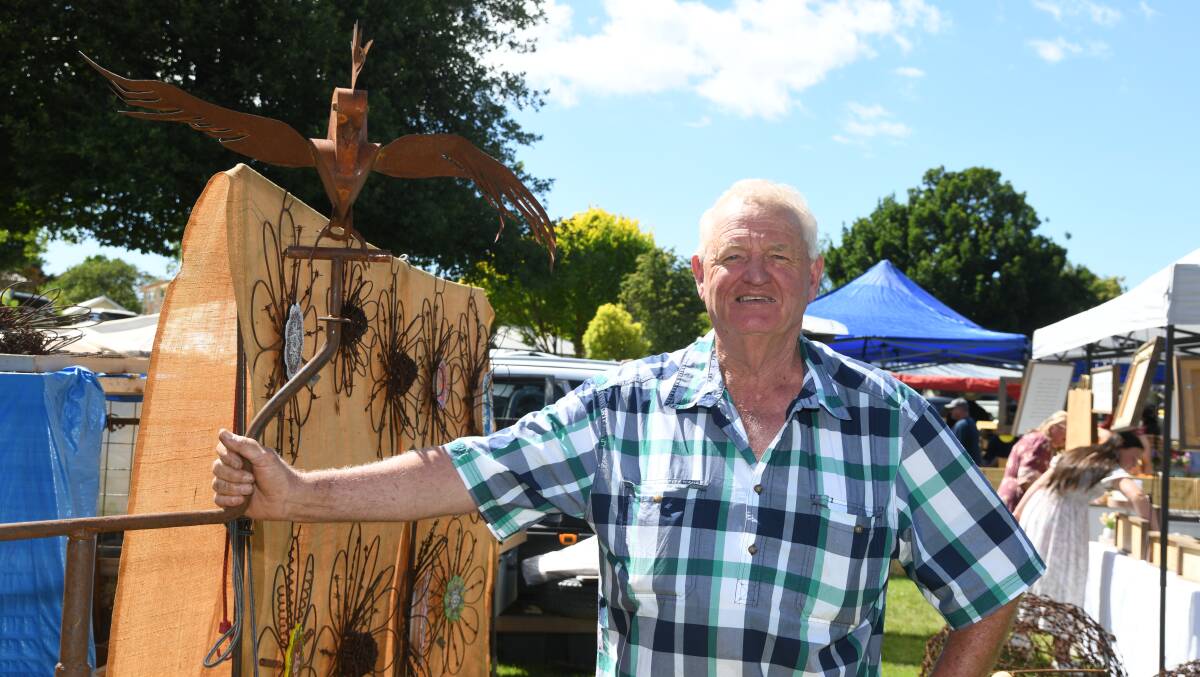 Rusty Barbs Designs owner Stewart Litchfield with one of the garden sculptures he was selling at the Millthorpe Markets on Sunday. Picture by Jude Keogh