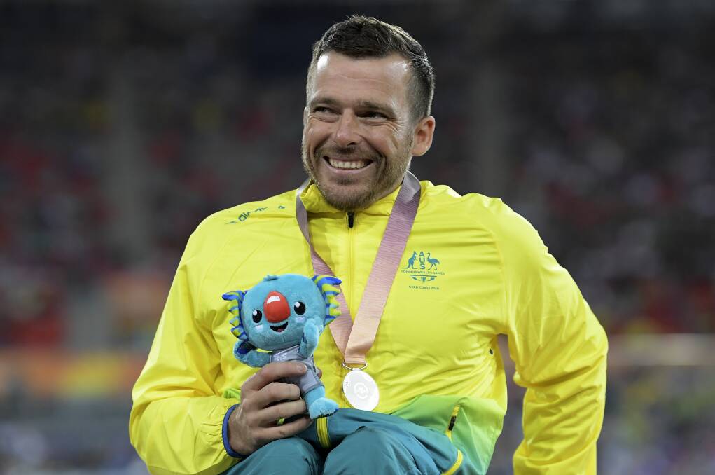 SILVER LINING: Kurt Fearnley is all smiles after claiming a Commonwealth Games silver medal on Tuesday night. Photo: AAP/TRACEY NEARMY