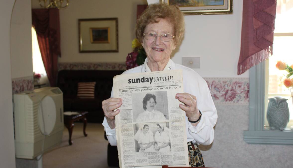 SKILLFUL WOMAN: Valerie Monroe holding an article written in 1993 - when she retired - with a photo of her and sister Frances Woodward. Photo: MAX STAINKAMPH.