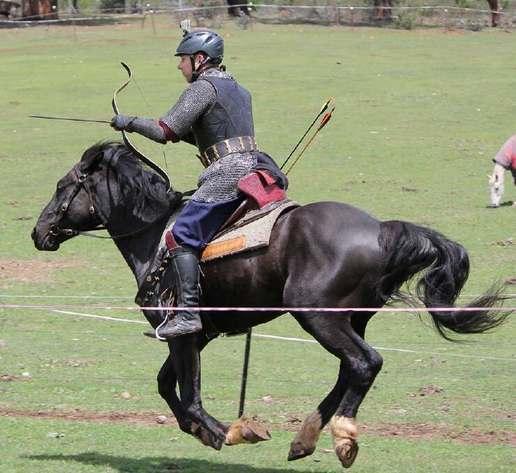 GIDDY UP: Rod Walker in action with the bow on horseback. He'll be the main attraction at the Neville Show this Saturday. Photo: SUPPLIED. 