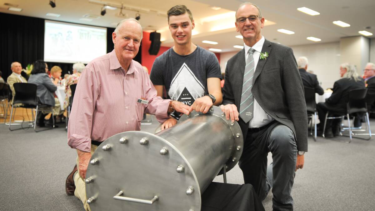 BACK TO THE FUTURE: David Kingham, Sam Batty and Scott Ferguson with the time capsule set to be unearthed in 2118. Photo: ZENIO LAPKA. 