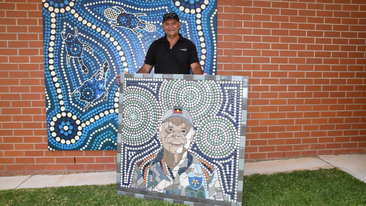 Ron Spencer poses with the artwork of himself made by David Sawtell and the Connections group. Picture by Carla Freedman