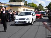 A procession of cars leaves the Orange Function Centre following the funeral for John Davis. Picture by Jude Keogh