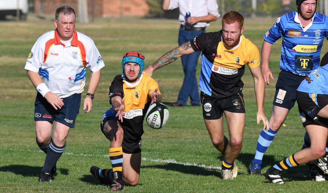 TOUGH GAME: Nick Plunkett flings the ball to a teammate during his side's opening New Holland Agriculture Cup clash with the Blayney Rams. Photo: CHRIS SEABROOK