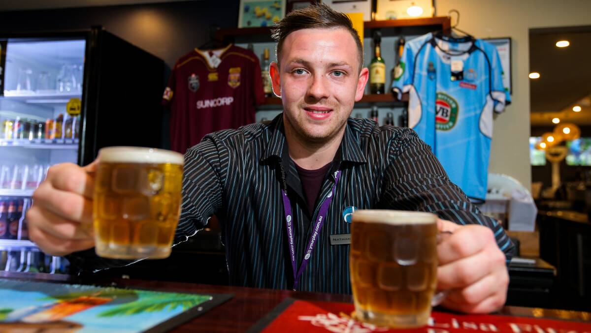 Cheers: Rafferty's Tavern staff member Nathan Danskin with two pots of beer, which have been shown to be more effective than two paracetamol tablets at relieving pain. Picture: Rob Gunstone