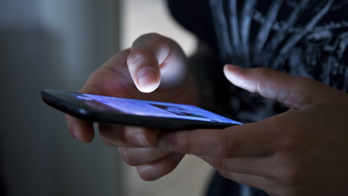 A file image of a person using a mobile phone.