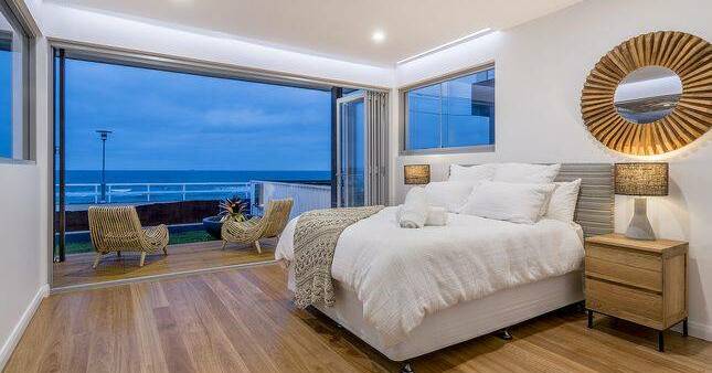 A bedroom at The Beach House with spectacular views of the ocean.