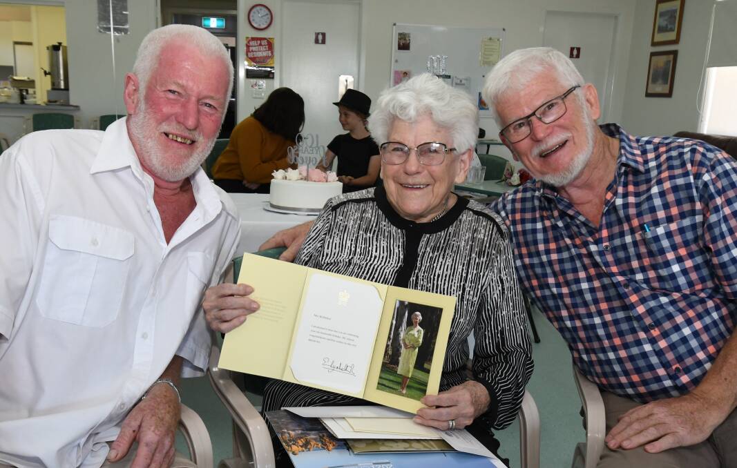 REMARKABLE: Marie McMullen with her letter from the Queen and her sons, John and Peter Speers, at her 100th birthday celebration on Saturday. PHOTO: JUDE KEOGH