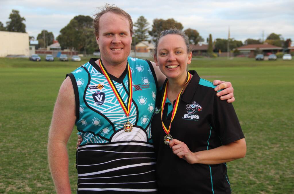 Erin Freeland, right, with Todd Matthews of the Swifts after winning Tim Chatfield medals.
