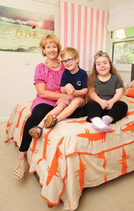 UNBREAKABLE BOND: Michelle Kearns at home with her grandchildren Justin Oliver, 7, and Christell Papadakis, 17. Picture: Kieren L Tilly