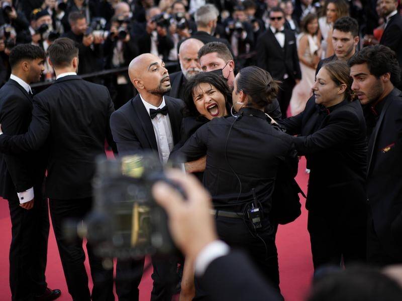 Woman stages semi-naked protest at Aussie director George Miller's premiere at Cannes Film Festival.