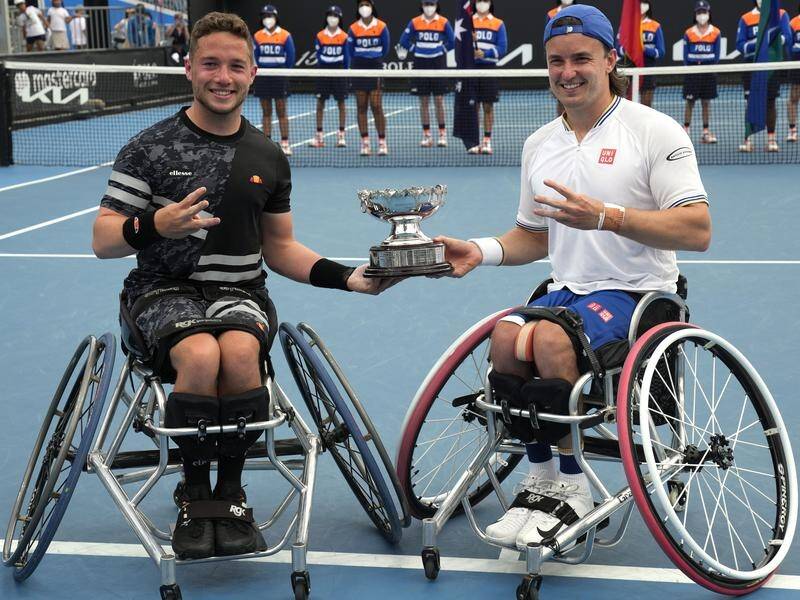 Alfie Hewett (L) and Gordon Reid pose with their Australian Open wheelchair doubles trophy.
