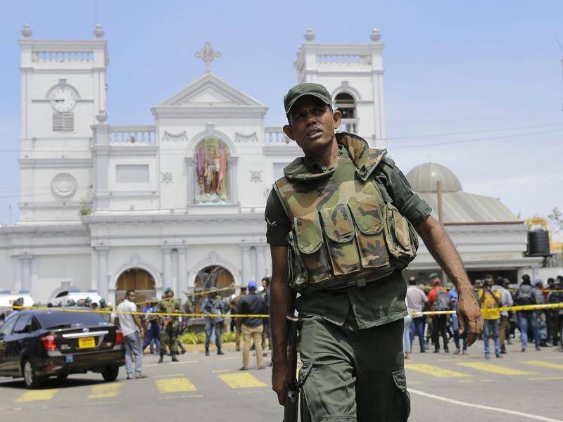 Sri Lankan Army soldiers secure the area around a church following deadly bomb blasts.