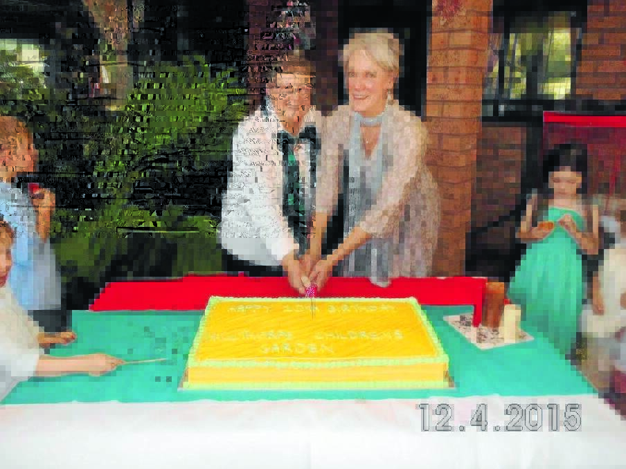 Judith Boag and Pirkko Monds cutting the cake to celebrate 10 years of Millthorpe Children's Garden.