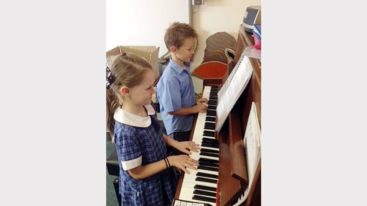 PARKES: Seven year olds Matilda Wilson and Xandy McGregor enjoy their music lessons. 
