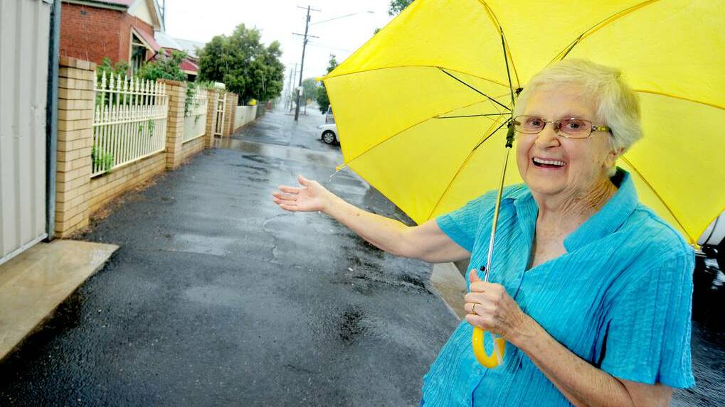 DUBBO: Janet McColl enjoys the rain in Dubbo on Wednesday.