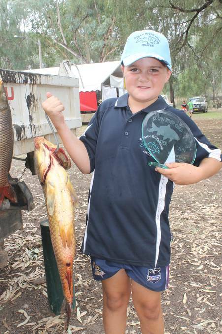 NYNGAN: Champion angler Tyson Stapleton with his trophy and award-winning catch at the carp muster.