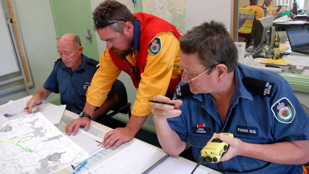 John Cole, Brett McMillan and Greg Standen were manning the communications room at Evans Rural Fire Service Headquarters Command Centre during the worst of the fires.