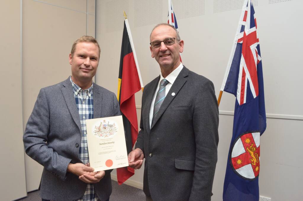 WELCOME: Andrew Orme-Smith is presented with his citizenship certificate by Blayney mayor Scott Ferguson. Photo: DECLAN RURENGA