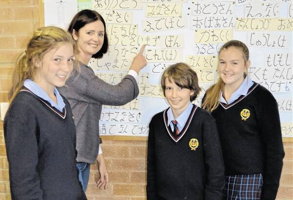 LEARNING LANGUAGES: James Sheahan Catholic High School Japanese teacher Michelle Whiteley gives Olivia Fitzpatrick, Monique Kerwick and Brendon Geoghegan a lesson. Photo: NICOLE KUTER 0517nklanguage