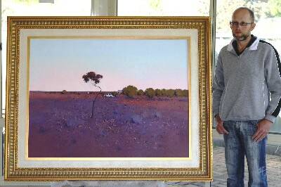 IN THE RUNNING: Newbridge artist David Lake with his award nominated landscape painting of a scene at White Cliffs, in the states far west.  Photo:  ALEN DELIC