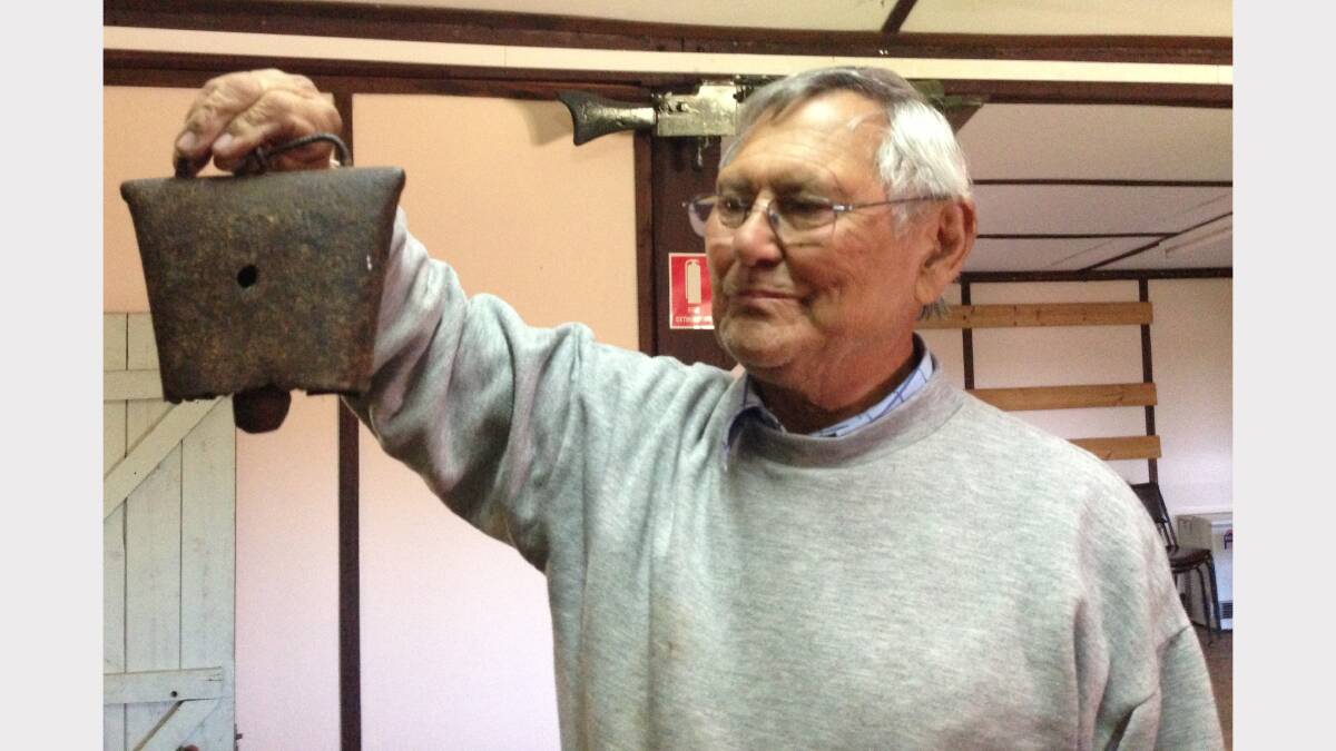 Donald Young with an old cow bell memento in the Hobbys Yards' hall.