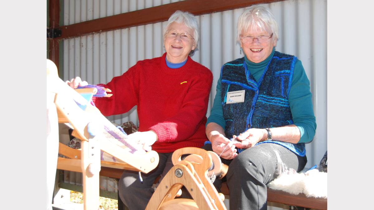 Sisters having a yarn. With a loom and a spinning wheel in full production, Anne O’Connor and Dawn Williams managed a chat at the Carcoar wool and fibre muster.  Photo: Wayne Cock.
