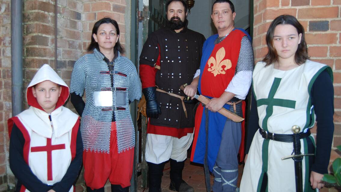 Nathan, Lisa and Lauren Wells representing MCC (medieval combat and culture) with Jack Mann and Aaron Sanderson (centre) of Denizens Of Ethos guard the entrance to St. Paul’s church in Carcoar. Photo: Wayne Cock.